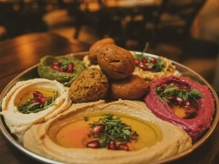 Traditional Mediterranean mezze spread featuring hummus, baba ganoush, falafel, and fresh pita at Carnys restaurant